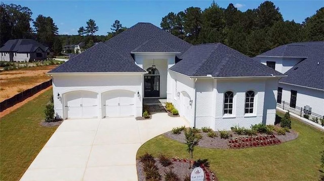 view of front of house with a front yard and a garage