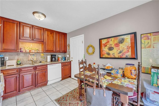 kitchen featuring light tile patterned flooring, sink, dishwasher, light stone countertops, and backsplash