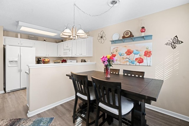 dining room with a chandelier and hardwood / wood-style floors