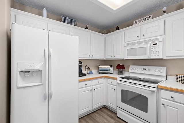 kitchen with white cabinetry, dark wood-type flooring, white appliances, and a textured ceiling