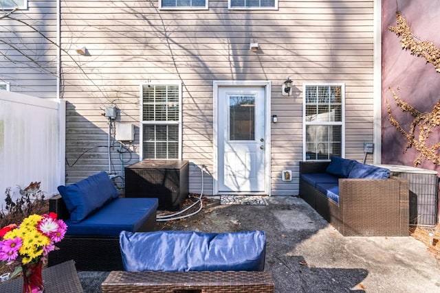 doorway to property featuring an outdoor living space, central AC, and a patio