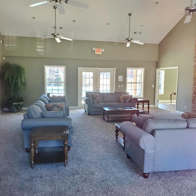 living room featuring high vaulted ceiling, french doors, and carpet flooring