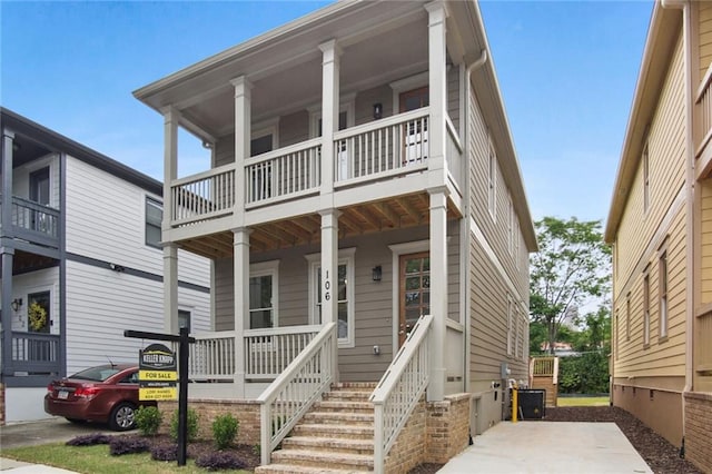 view of front facade with central AC and a porch