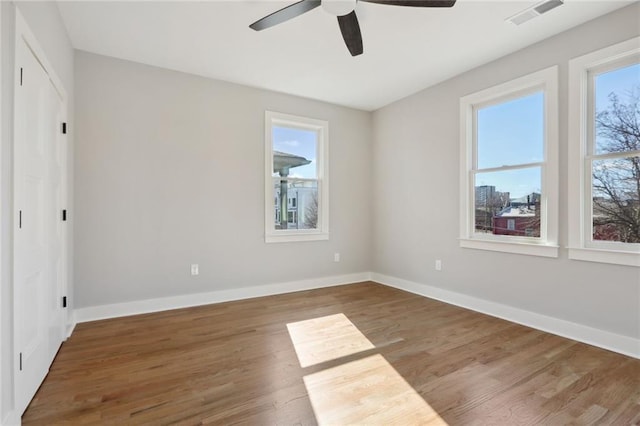 spare room featuring ceiling fan and dark wood-type flooring