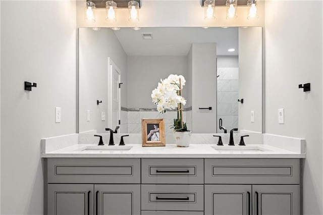 bathroom with vanity and a shower with shower door