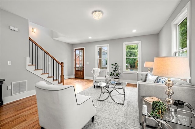 living room featuring a wealth of natural light and light hardwood / wood-style flooring