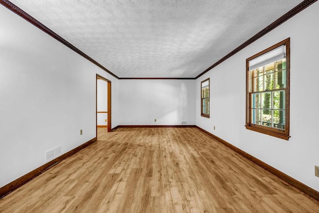 2775 Doaks Run Ct, Tucker, GA 30084 - empty room featuring light wood-type flooring, crown molding, and a textured ceiling