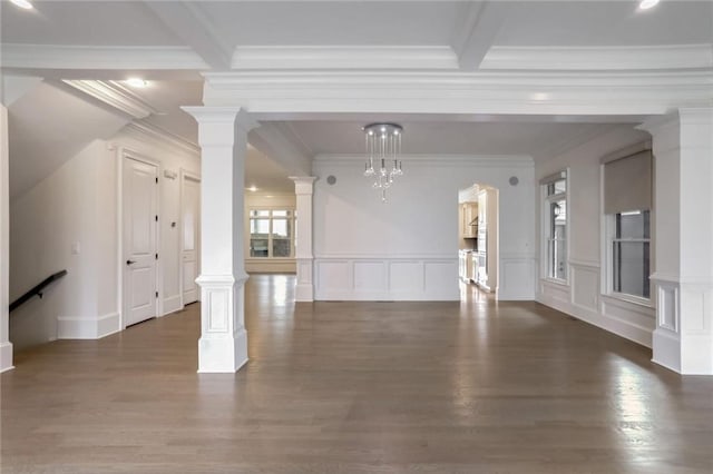 unfurnished living room featuring dark wood finished floors and decorative columns