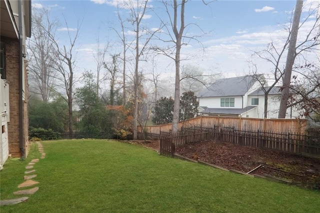 view of yard with a fenced backyard