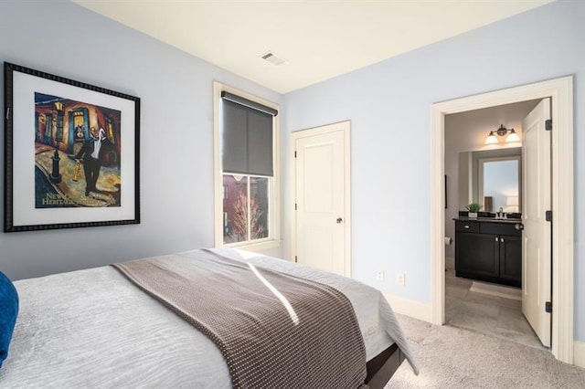 bedroom with baseboards, a sink, visible vents, and light colored carpet