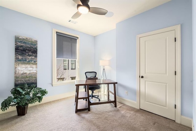 office space with baseboards, ceiling fan, visible vents, and carpet flooring