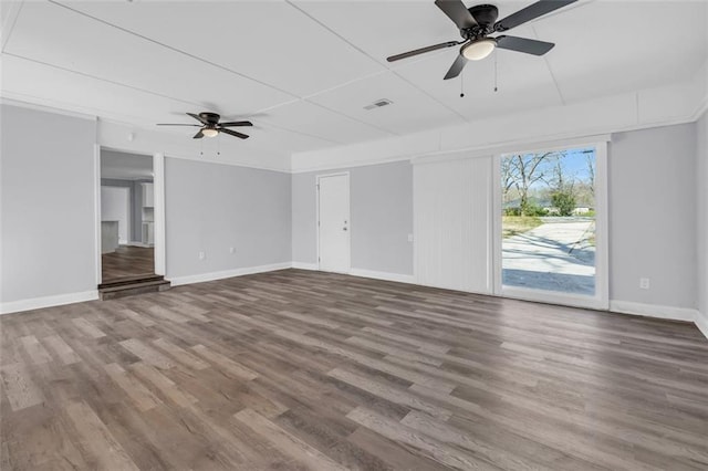 unfurnished living room featuring ceiling fan, wood finished floors, visible vents, and baseboards