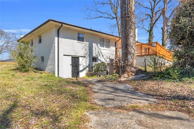 rear view of property with brick siding