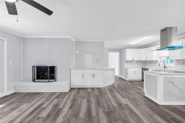 unfurnished living room featuring a brick fireplace, crown molding, and dark wood-type flooring