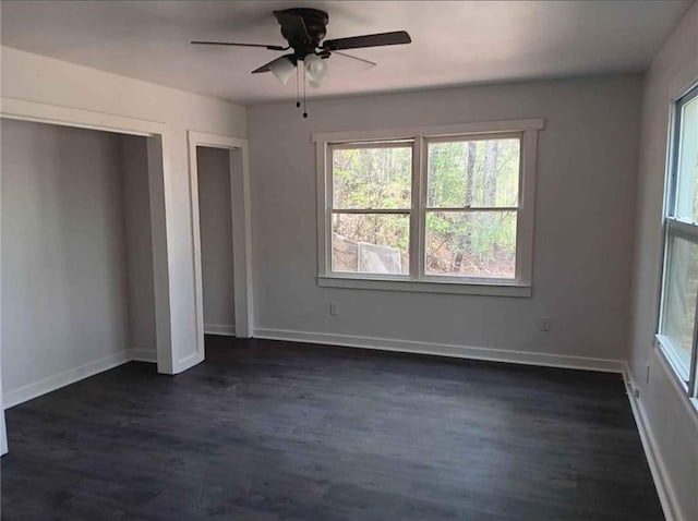 240 Varnes Ln, Lakemont, GA 30552 - unfurnished bedroom with multiple closets, multiple windows, and dark wood finished floors