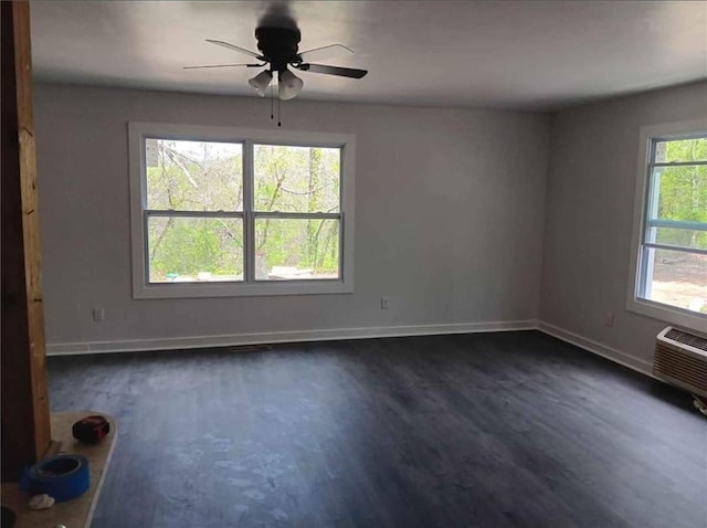 240 Varnes Ln, Lakemont, GA 30552 - unfurnished room featuring dark wood-style floors, ceiling fan, and a wall unit AC