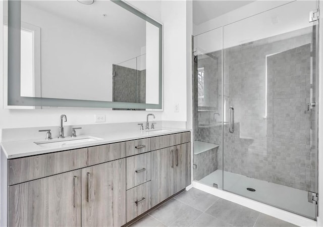 bathroom featuring tile patterned flooring, vanity, and an enclosed shower