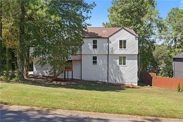 view of home's exterior with a wooden deck and a lawn