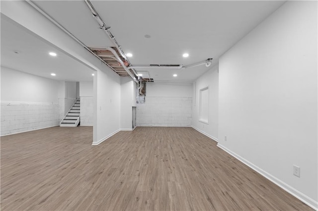 basement with light hardwood / wood-style flooring