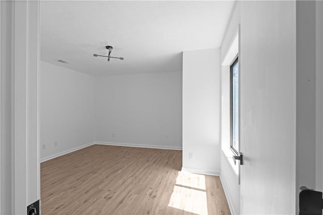 unfurnished room with light hardwood / wood-style floors