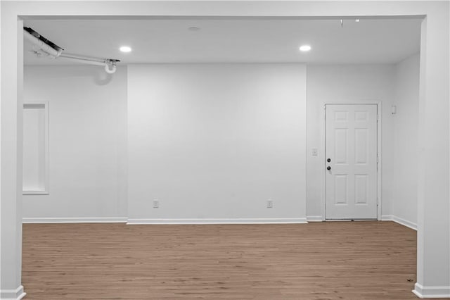 empty room with hardwood / wood-style flooring