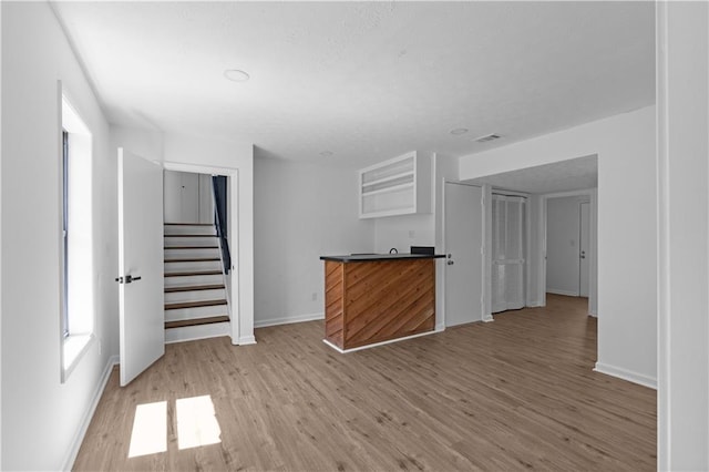 unfurnished living room with light hardwood / wood-style flooring