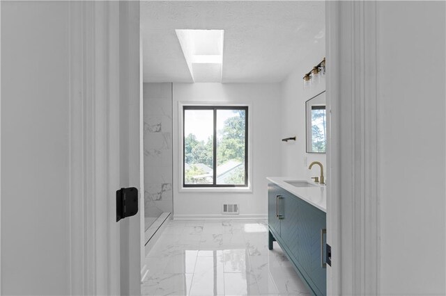 bathroom with vanity and a shower with shower door