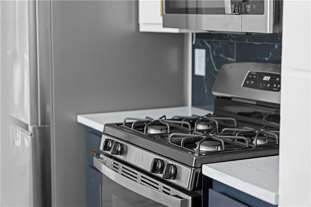 kitchen with stainless steel appliances and tasteful backsplash