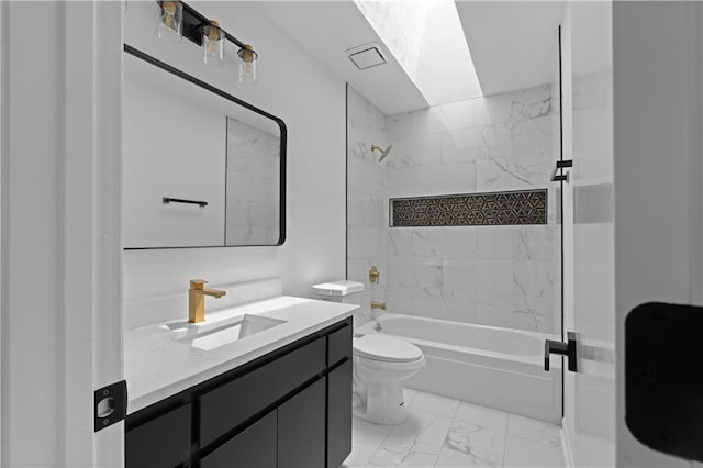 full bathroom with tiled shower / bath, vanity, and toilet