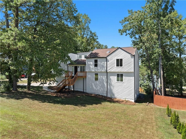 rear view of house featuring a lawn