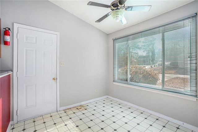 spare room with ceiling fan and vaulted ceiling