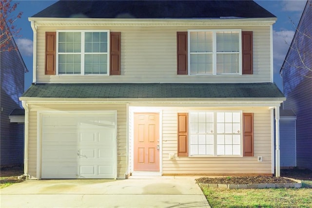 view of front of property with a garage and concrete driveway