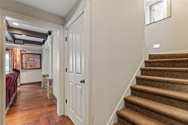 stairs with coffered ceiling, visible vents, wood-type flooring, beamed ceiling, and baseboards