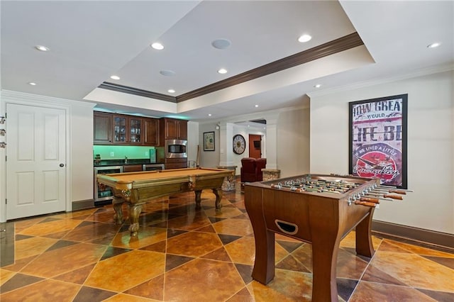 rec room with a tray ceiling, wet bar, recessed lighting, pool table, and ornamental molding