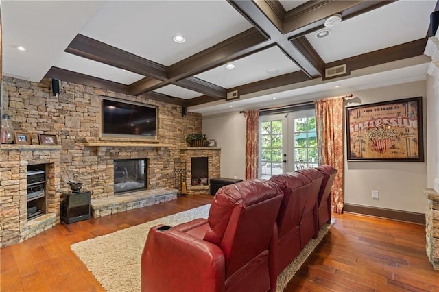 living room with ornamental molding, beam ceiling, hardwood / wood-style floors, and a fireplace
