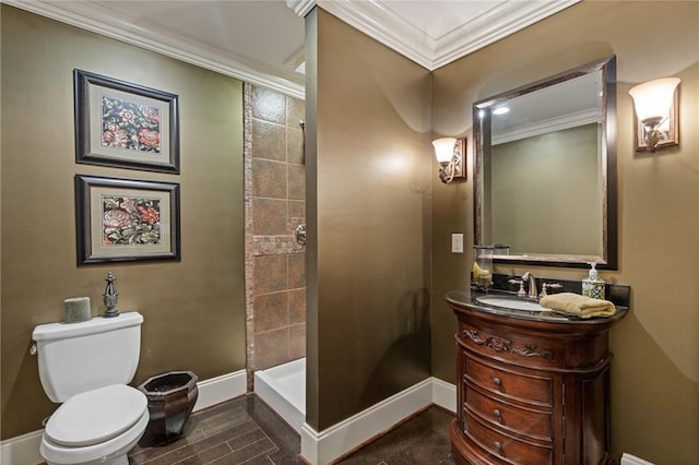 full bath with toilet, vanity, ornamental molding, baseboards, and a stall shower