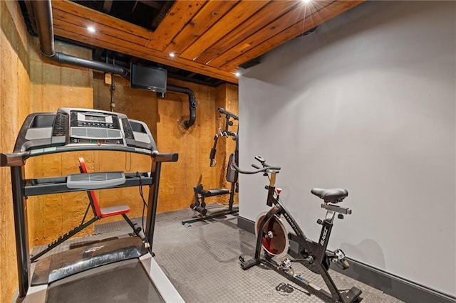 workout room featuring wood walls and recessed lighting