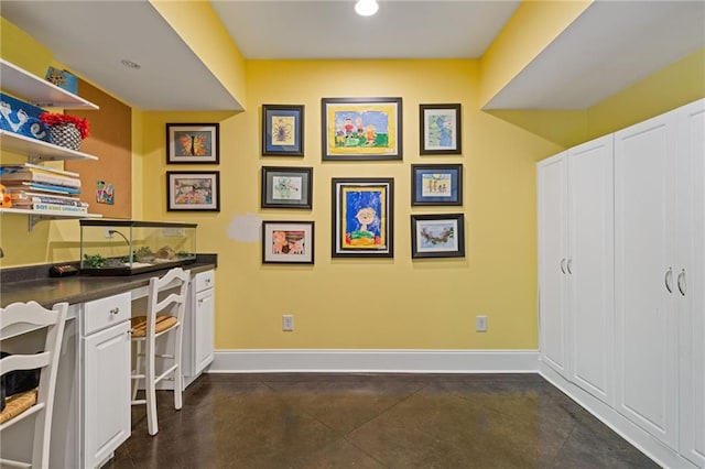 office area featuring recessed lighting, concrete flooring, and baseboards