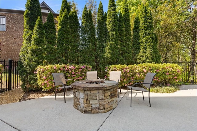 view of patio with fence and an outdoor fire pit