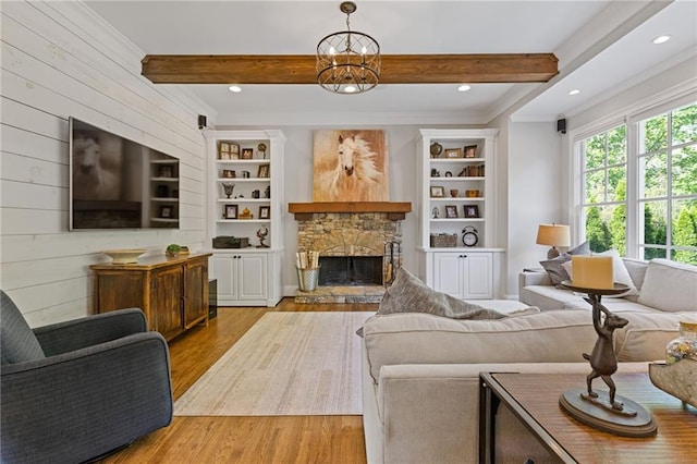 living area with crown molding, wood finished floors, a fireplace, beam ceiling, and recessed lighting