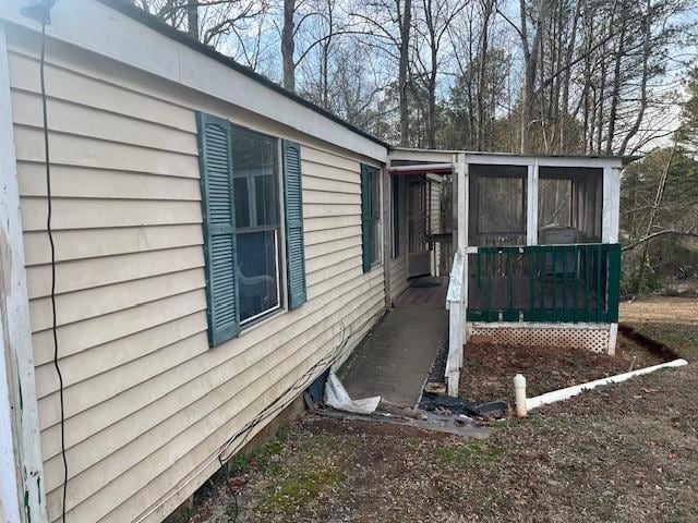 view of side of home with a sunroom