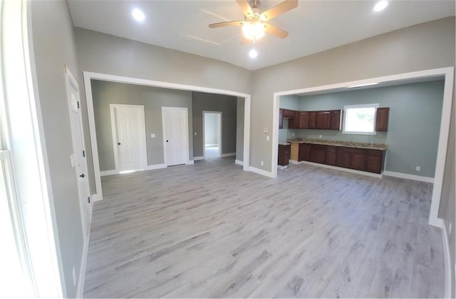 unfurnished living room featuring light wood-type flooring and ceiling fan