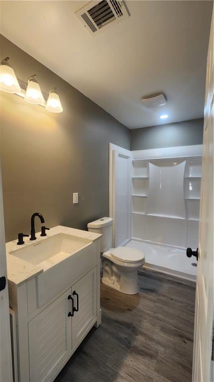 bathroom featuring hardwood / wood-style floors, vanity, and toilet