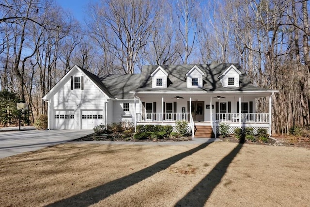 cape cod-style house featuring ceiling fan, a garage, covered porch, and a front lawn