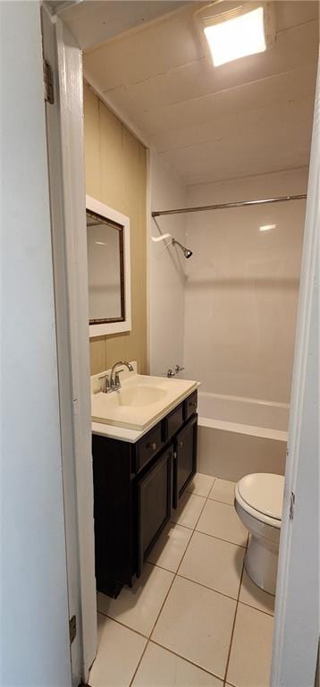 full bath featuring toilet, tile patterned flooring, vanity, and bathing tub / shower combination