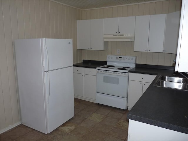 kitchen with dark countertops, white appliances, under cabinet range hood, and a sink