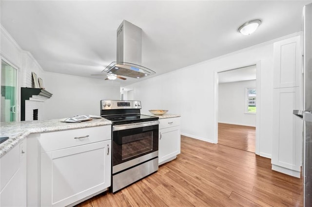 kitchen featuring crown molding, ceiling fan, white cabinetry, island range hood, and electric stove