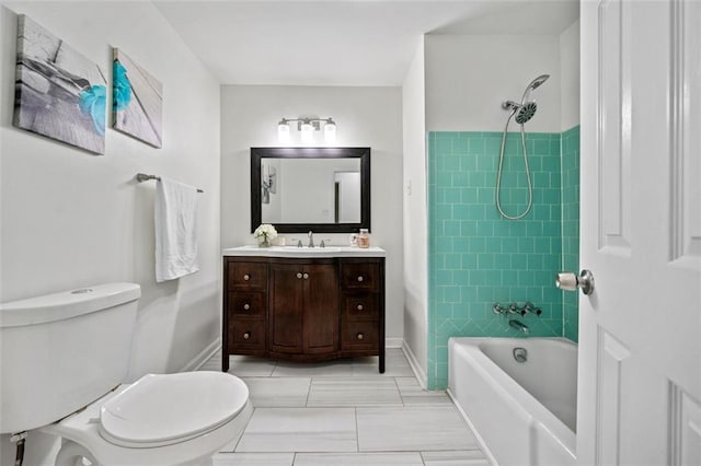 bathroom featuring toilet, baseboards, vanity, and bathtub / shower combination