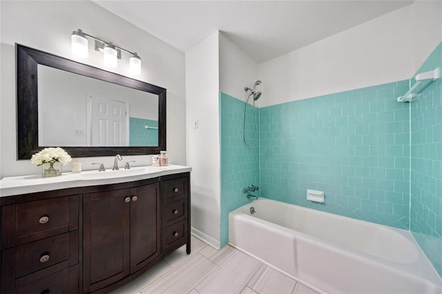 bathroom with tile patterned floors,  shower combination, baseboards, and vanity