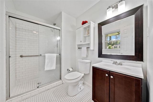 full bath featuring vanity, toilet, baseboards, and a shower stall